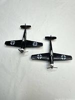 Top view of both black diecast planes showing wingspan and markings