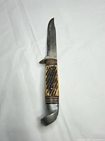 Full knife view showing blade, guard, handle and pommel