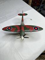 Top front view of Spitfire model showing camouflage paint, RAF roundels, propeller, cockpit canopy