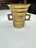 Front view showing shape, handles, surface condition