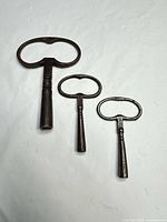 All three iron clock winding keys showing relative sizes