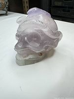 Side view showing lavender quartz skull with snake detail