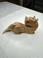 Left-side view of entire stone mythical beast statue