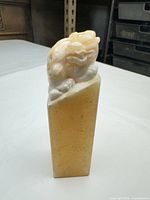 front view of carved soapstone seal with guardian lion