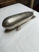 Side view showing bomb shape with wheel and removable midsection seam