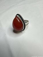 Front view of ring showing teardrop carnelian cabochon and rope bezel