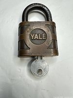 Front view of Yale brass padlock with key inserted