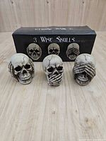 Three skull figurines with original box