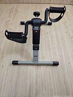 Full view of AGM mini pedal exerciser showing pedals, base and console