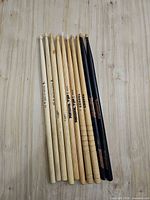 All ten drumsticks laid flat showing full length and brand markings