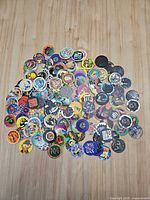 Full lot of mixed pogs and slammers spread on tabletop