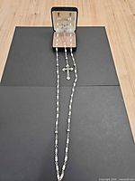 Rosary laid out full length with box at top