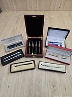 Overall view of all boxed pen sets on tabletop