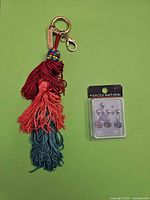 Front view of keychain and blister pack of belly rings