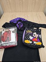 Overall lot with robe, mask, packaged cape, Mickey bag visible