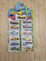 Full lot of 12 carded Hot Wheels cars laid out