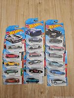 Front view of two vertical stacks of 16 Hot Wheels cars on cards