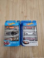 Front view of two sealed Hot Wheels 3-car packs