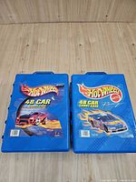 Both blue Hot Wheels 48-car carry cases closed, front graphics visible