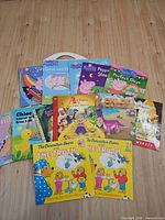 Group shot of all eleven books spread on wood floor