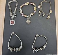 All five bracelets arranged on black background