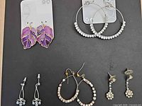 All five earring pairs displayed on black background