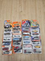 Group shot of all 28 blister-card cars arranged in four columns on tabletop