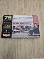 Front of closed box showing Matchbox logo, 75th Anniversary branding, storefront photo