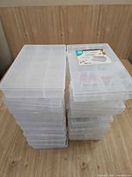 Two tall stacks of clear plastic storage boxes