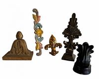 Five assorted decorative wall pieces displayed upright on white background