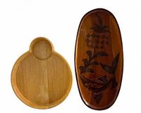 Front view of both wooden serving boards, showing shapes and carved design
