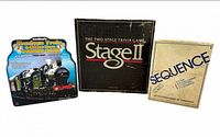 Front view of three game boxes: Stage II, Sequence, Mexican Train dominoes