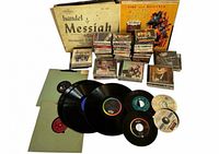 Overview of all media items: vinyl box set, stacks of cassette tapes, several CDs, loose LPs and singles