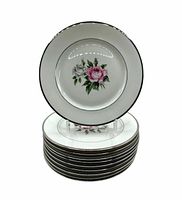 stack of ten plates showing floral design and rim