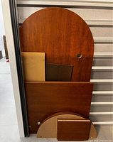 Stack of curved and rectangular wood panels