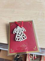 Front view of Lenox porcelain angel ornament on card