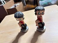 Two Betty Boop bobbleheads on table