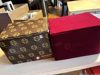Outer branded cardboard box and red presentation case