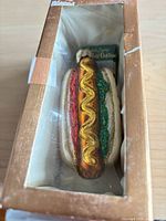 Ornament in box showing full hot dog design