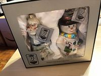 Boxed set showing Santa and snowman ornaments with PL tags