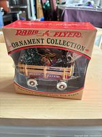 Front view of boxed Radio Flyer wagon ornament