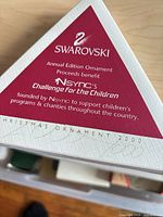 Outer sleeve showing Swarovski branding and NSYNC benefit note