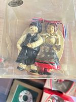 Ornament inside original plastic packaging showing brand label and couple design