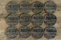 Front view of all 12 coins showing reverse design and legends