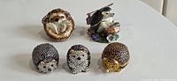 Group of five hedgehog trinket boxes showing variety