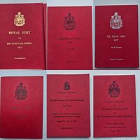 All six red Royal Visit staff booklets front covers displayed