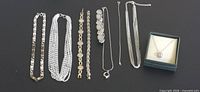 Group shot of all twelve jewellery pieces including boxed Mappins necklace