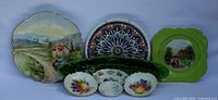 Group shot showing Limoges scenic plate, Schumann decorative plate, Italian leaf platter and three small accent plates