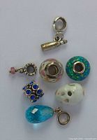 All six charms arranged on white background