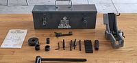 Overall lot showing case, bender body, handle, dies, pins, instruction sheet